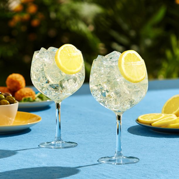 Two Gin & Bitter Lemon cocktails served on a sunny patio