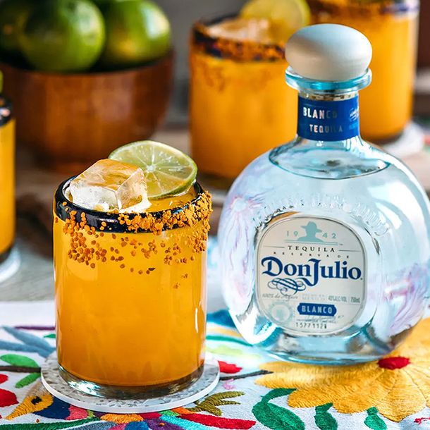 A Tumericana cocktail next to a bottle of Don Julio Blanco Tequila
