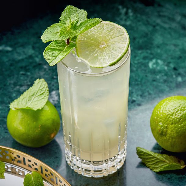 A Long Vodka served in a tall glass and garnished with lime and mint