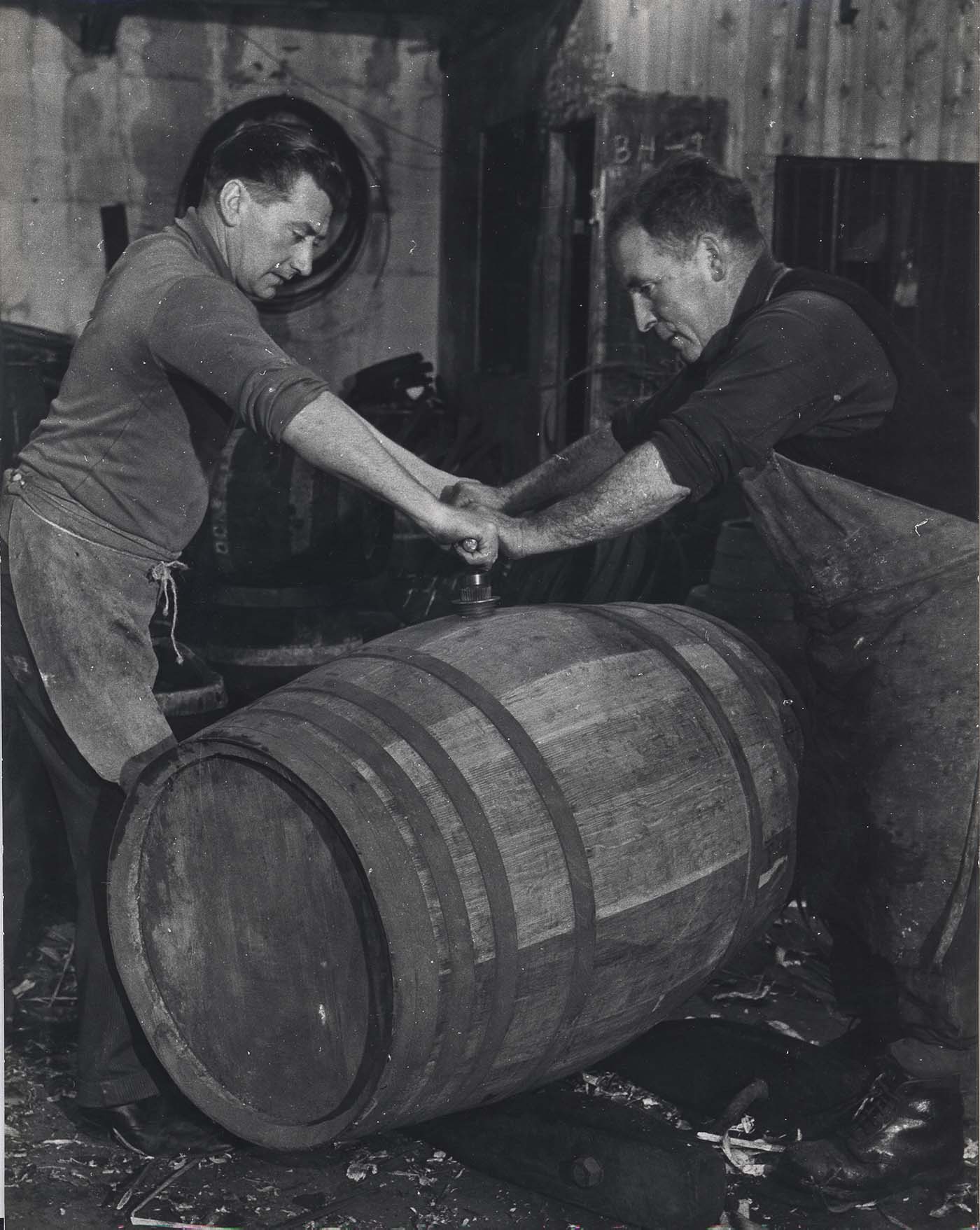 Two coopers working on a cask