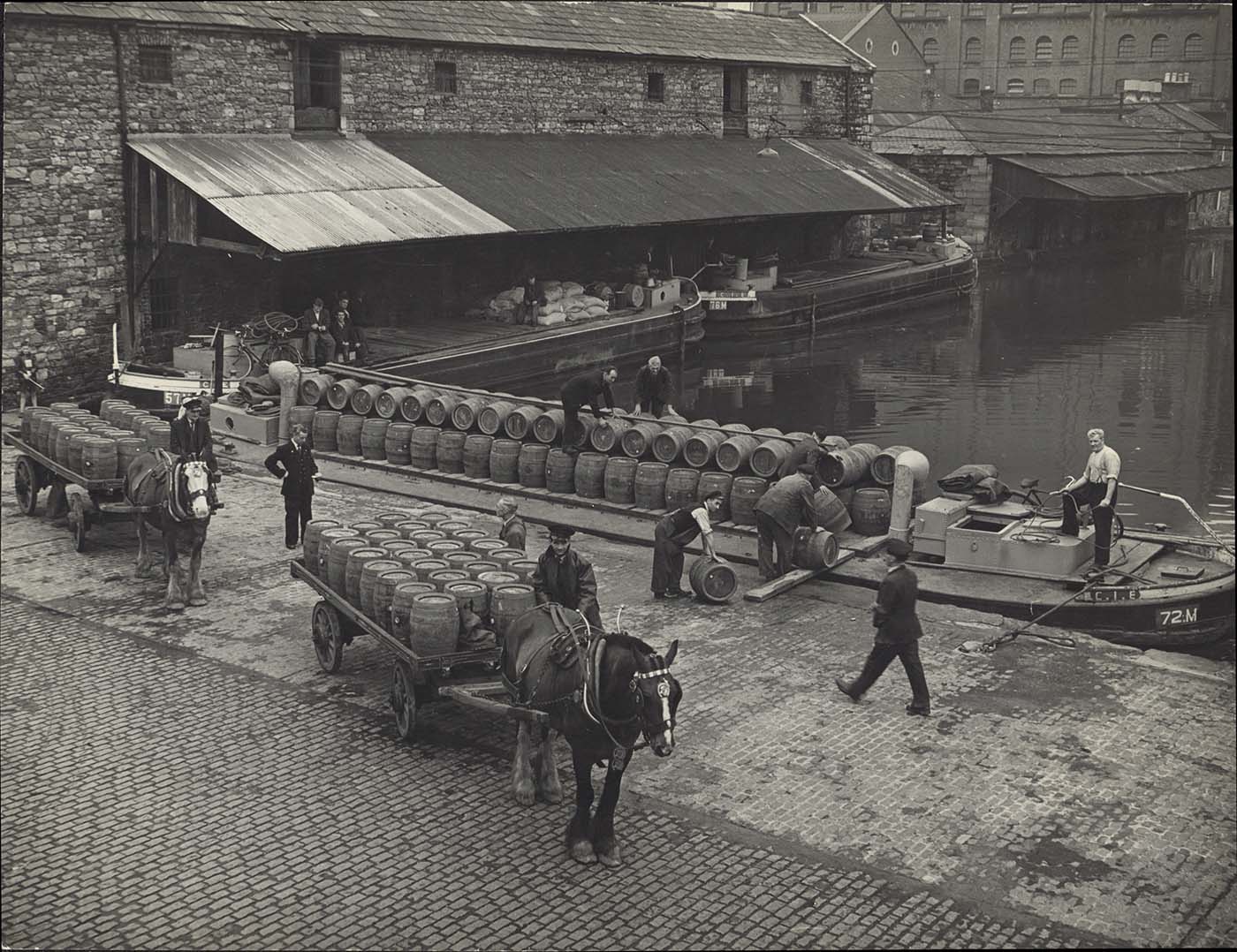 Black and white photograph of horses and drays at the Canal. 