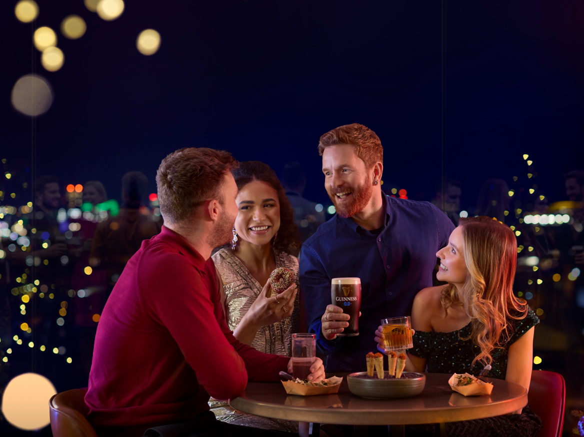 A group of friends enjoying Christmas at the Gravity Bar in Night at the Guinness Storehouse