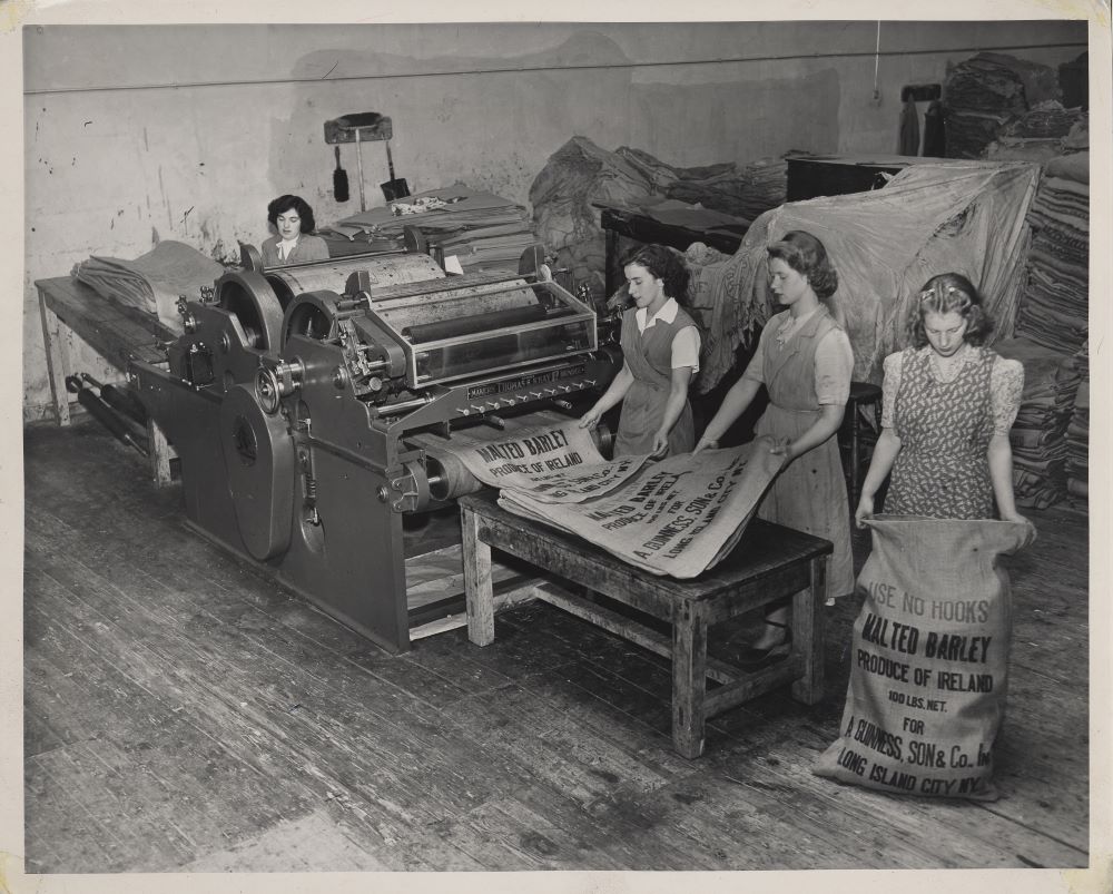 Four women working on a machine in the Guinness factory
