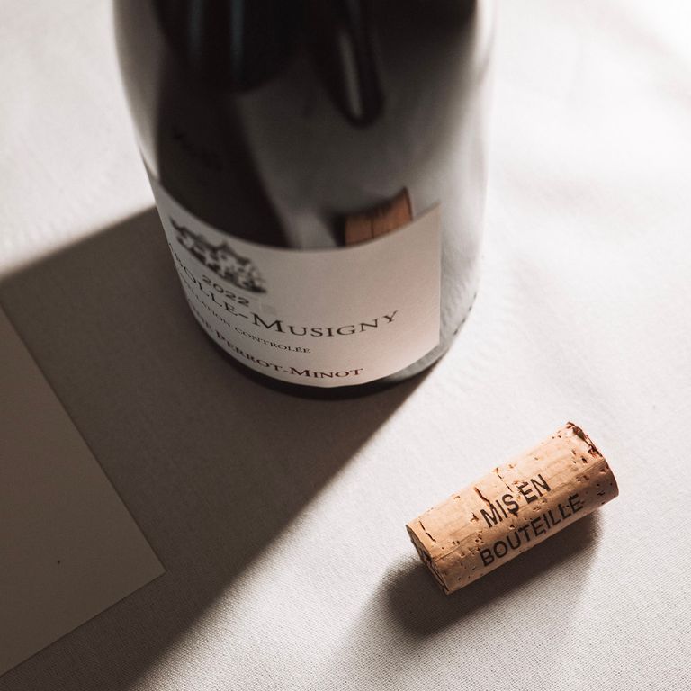 Wine bottle on table with cork next to it