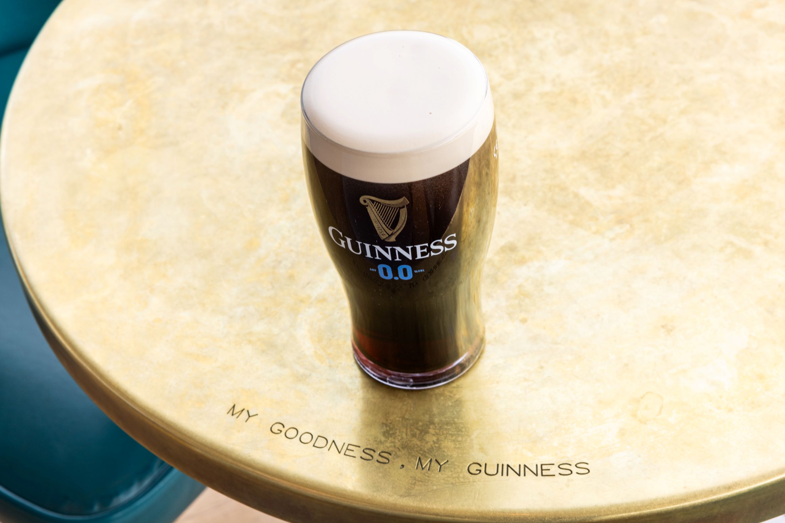 A beautiful pint of Guinness 0.0 perfect sit on a table where you can see engraved the tagline My Goodness, My Guinness