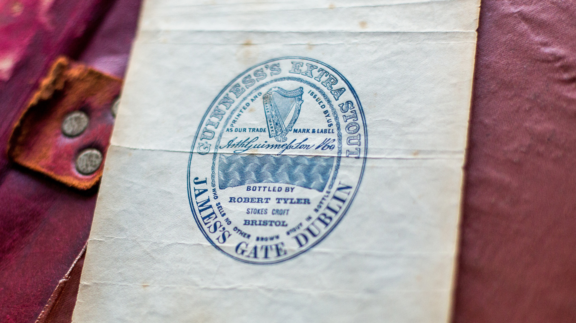 Original Guinness trademark label resting on a ledger. 