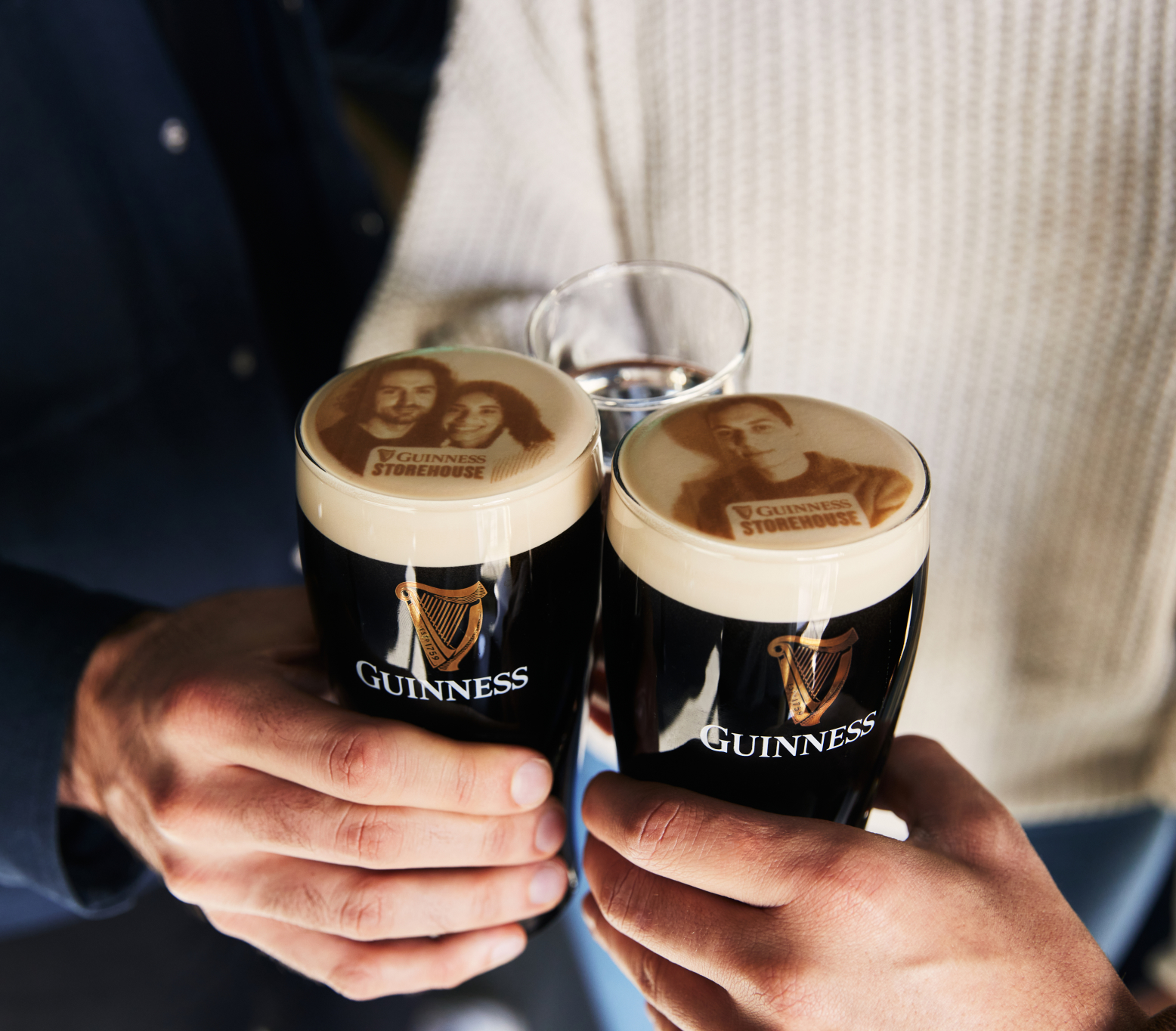 Two pints of Guinness with visitors faces printed on it