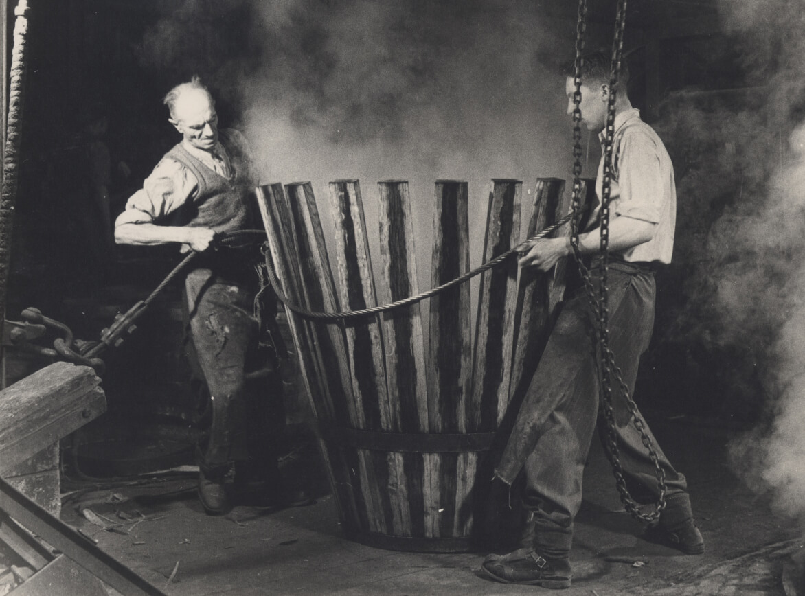 Two coopers at work steaming a cask, 1948.