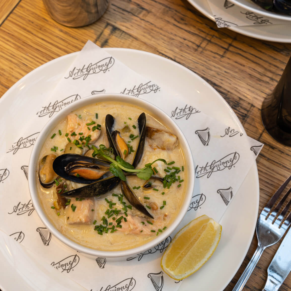 A top-down view of our classic Guinness moules frites with Guinness cream sauce and Roaring Water Bay Irish rope mussels. 