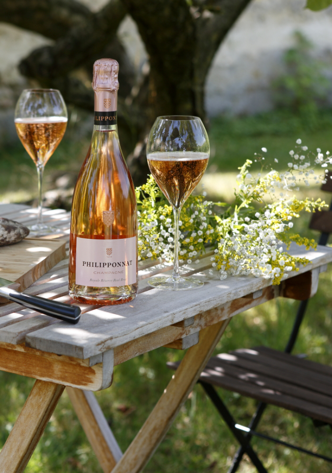 outdoor table with champagne bottle and champagne glasses