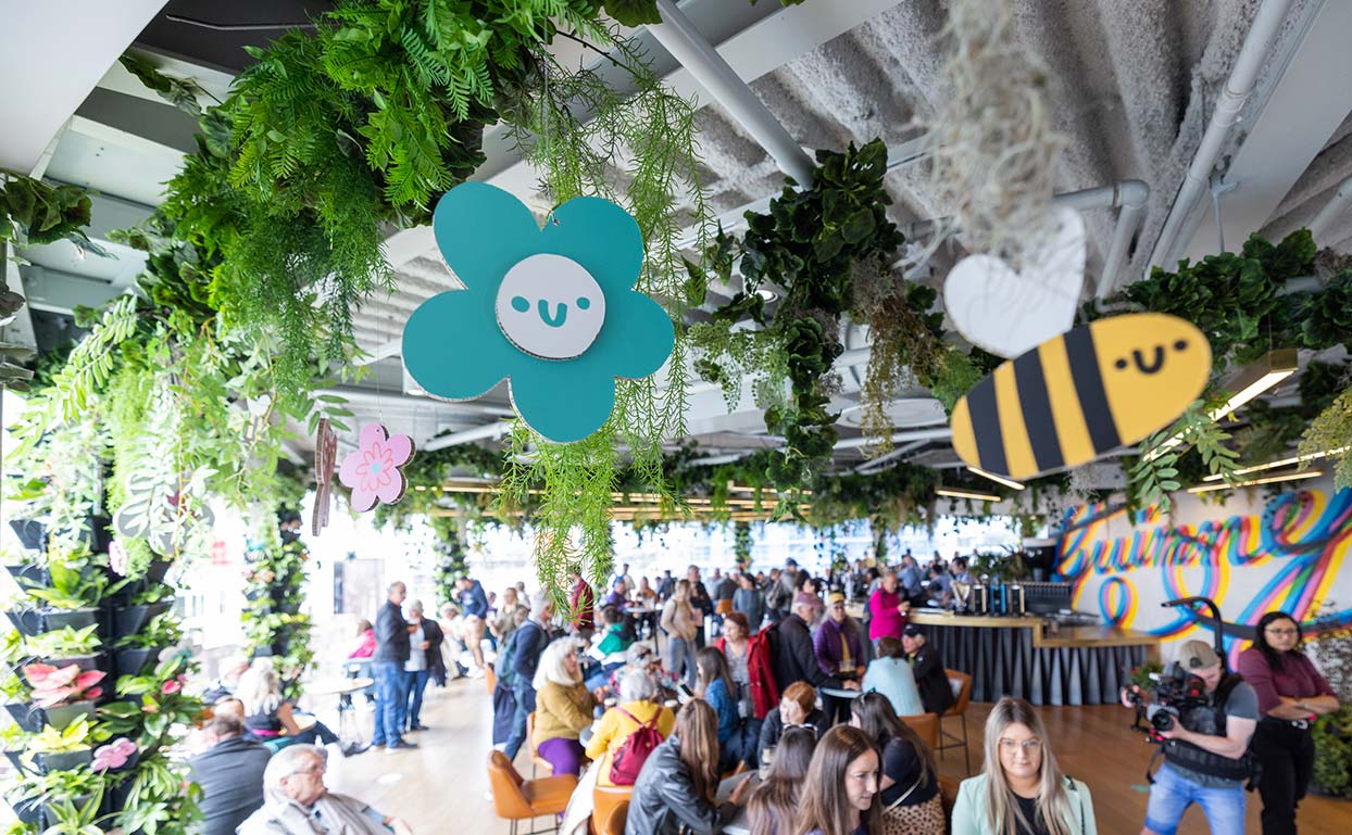 The Gravity bar full and busy with people enjoying drinks, surrounded by plants