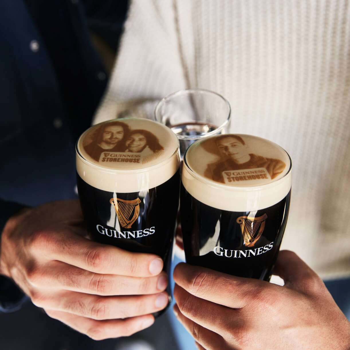 Two pints of Guinness with visitors faces printed on it